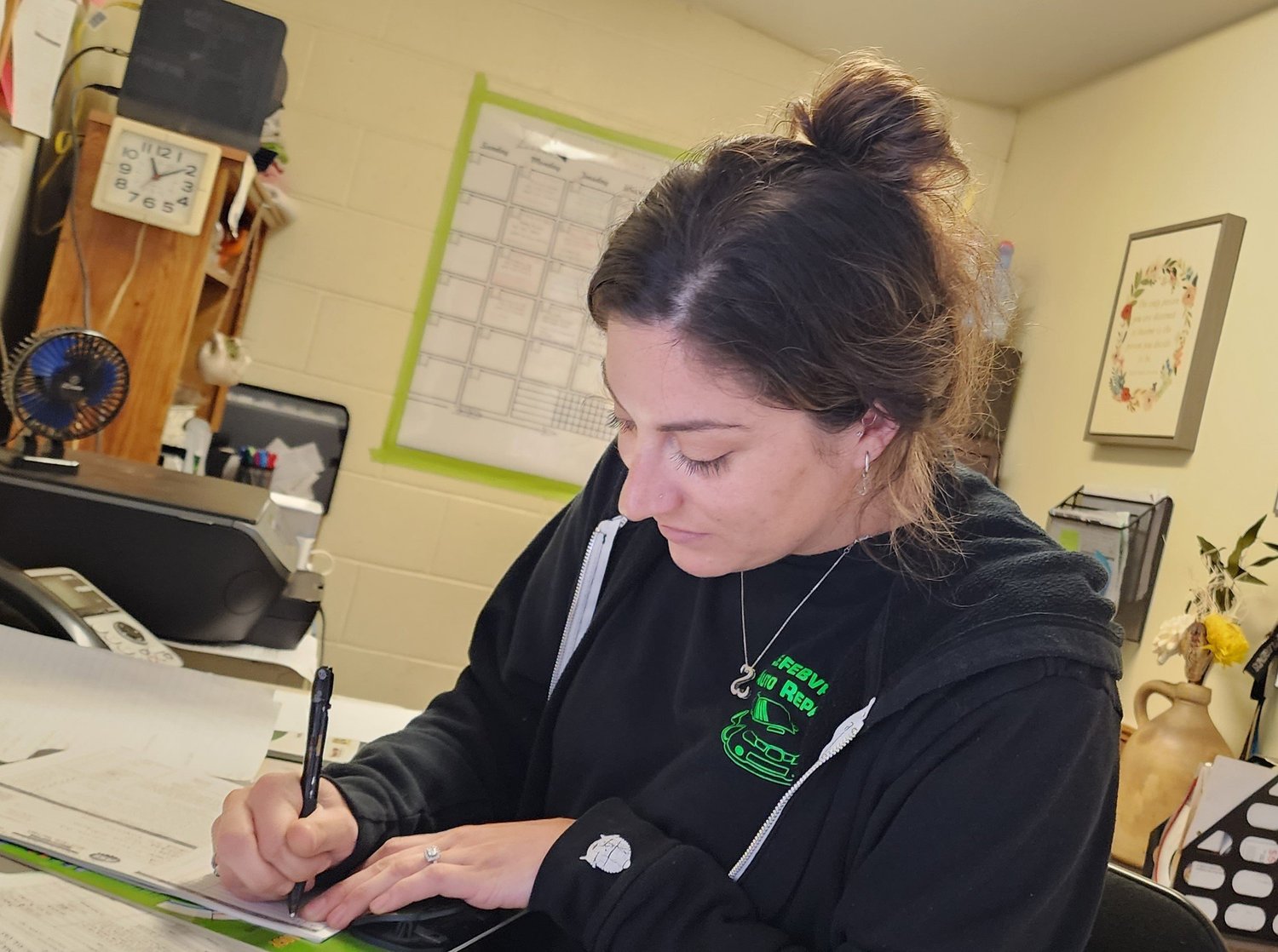 Writing paperwork at Lefebvre Auto Repair